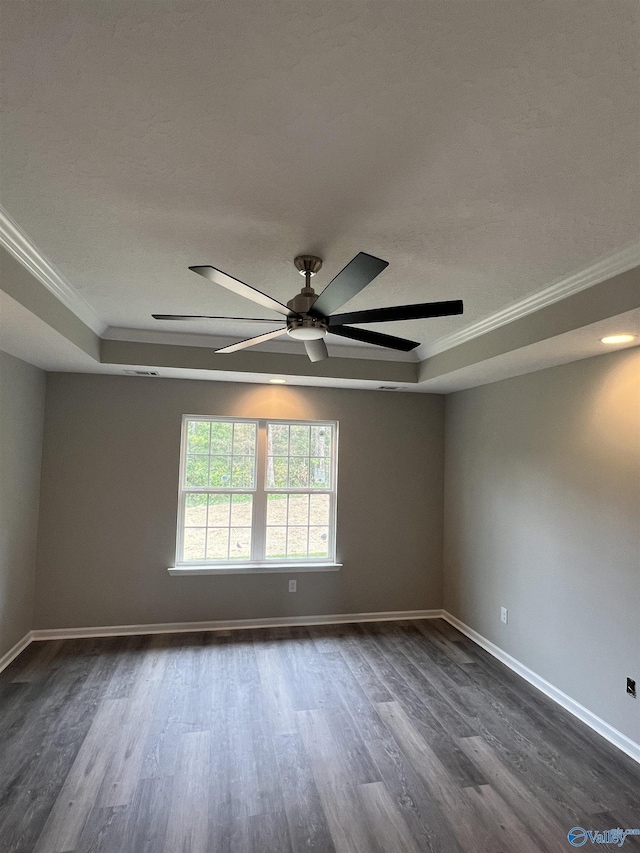 2385 Cedar Ridge Cir, Hokes Bluff, AL 35903 - empty room featuring ornamental molding, dark wood finished floors, ceiling fan, and a tray ceiling