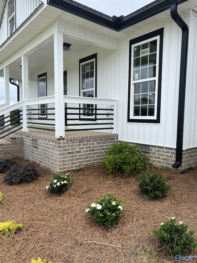 2385 Cedar Ridge Cir, Hokes Bluff, AL 35903 - view of home's exterior featuring crawl space, board and batten siding, and covered porch