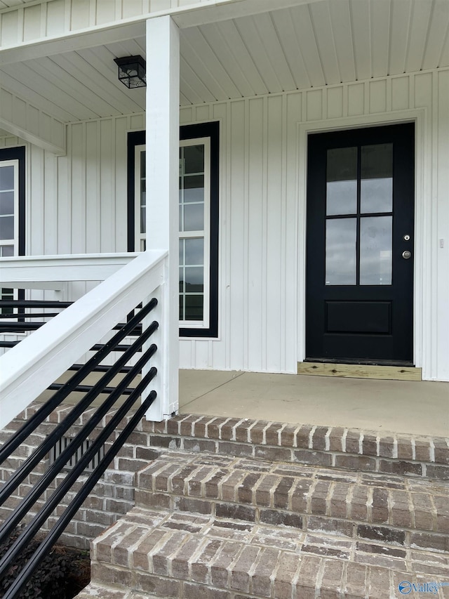 2385 Cedar Ridge Cir, Hokes Bluff, AL 35903 - doorway to property with covered porch and board and batten siding