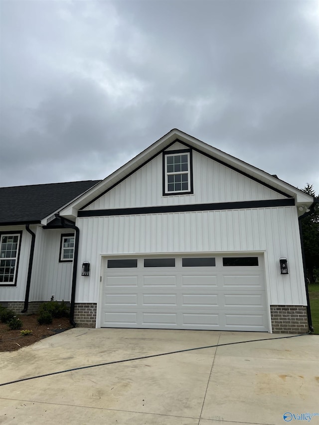 2385 Cedar Ridge Cir, Hokes Bluff, AL 35903 - view of front of home featuring concrete driveway, a garage, and board and batten siding