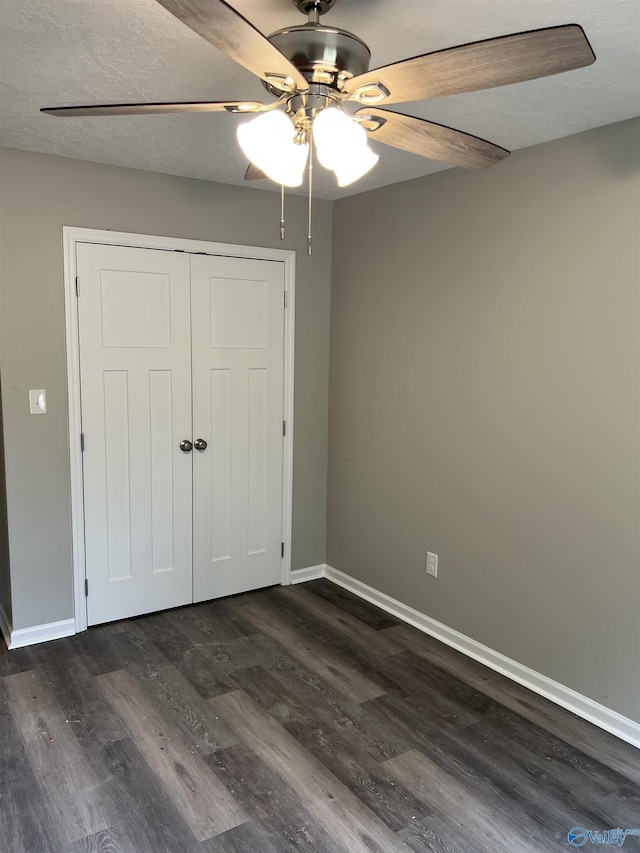 2385 Cedar Ridge Cir, Hokes Bluff, AL 35903 - unfurnished bedroom with dark wood-type flooring, a closet, and ceiling fan