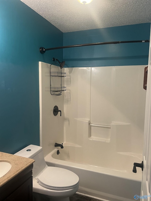 full bathroom featuring vanity, toilet, a textured ceiling, and washtub / shower combination