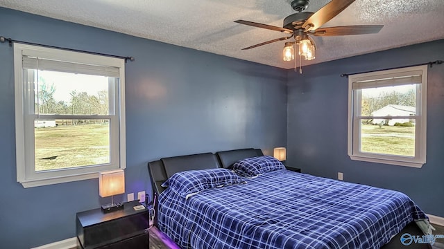 bedroom featuring ceiling fan and a textured ceiling