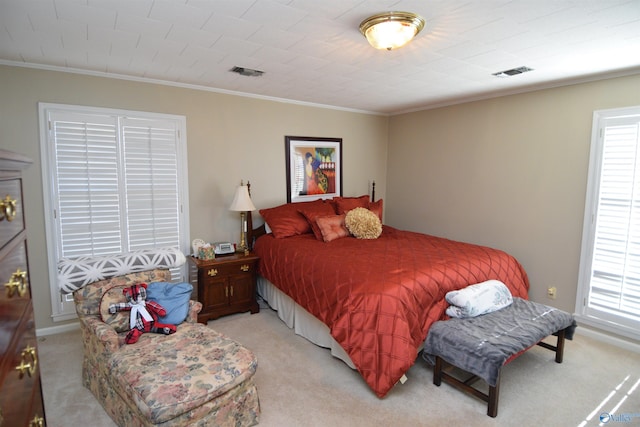 bedroom featuring visible vents, light carpet, and multiple windows