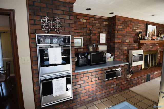 kitchen with heating unit, tile patterned flooring, double wall oven, and a warming drawer