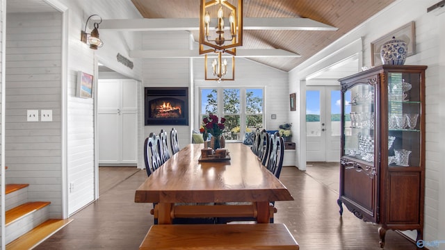 732 Bluff Dr, Rogersville, AL 35652 - dining room featuring a chandelier, wood finished floors, wooden walls, wood ceiling, and a warm lit fireplace