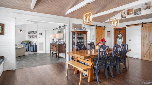 732 Bluff Dr, Rogersville, AL 35652 - dining room featuring a barn door, a chandelier, wood walls, and dark wood-style flooring