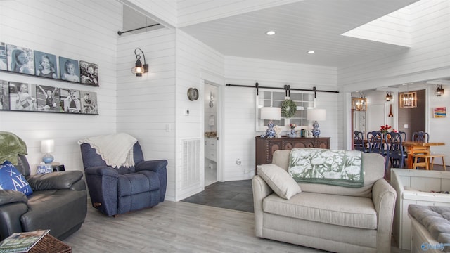732 Bluff Dr, Rogersville, AL 35652 - living area featuring a barn door, wood walls, recessed lighting, and wood finished floors