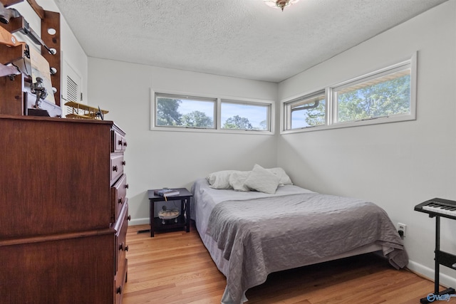 1308 Aston St, Athens, AL 35611 - bedroom with a textured ceiling, baseboards, and light wood-type flooring