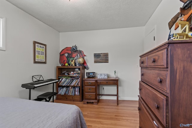 1308 Aston St, Athens, AL 35611 - bedroom featuring a textured ceiling and light wood-style flooring