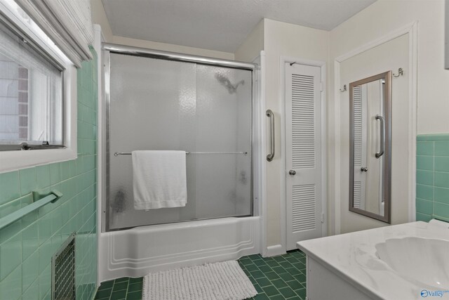 1308 Aston St, Athens, AL 35611 - bathroom with tile walls, vanity, tile patterned floors, a closet, and enclosed tub / shower combo
