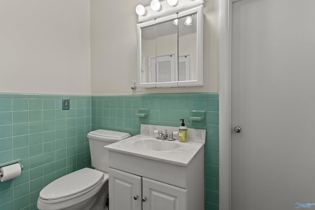 1308 Aston St, Athens, AL 35611 - bathroom with vanity, tile walls, wainscoting, and toilet