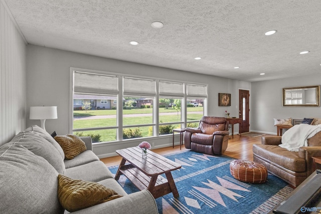 1308 Aston St, Athens, AL 35611 - living room featuring a textured ceiling, baseboards, recessed lighting, and wood finished floors