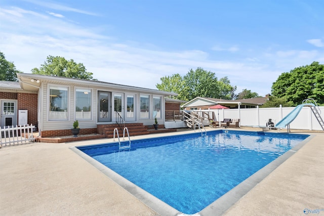1308 Aston St, Athens, AL 35611 - outdoor pool with entry steps, fence, a water slide, and a patio area