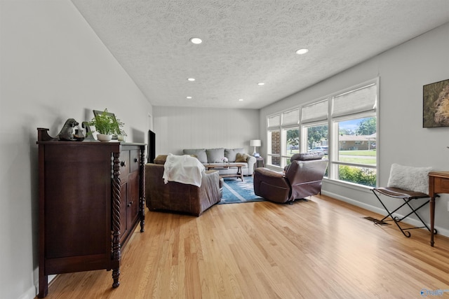 1308 Aston St, Athens, AL 35611 - living area featuring recessed lighting, a textured ceiling, baseboards, and light wood finished floors