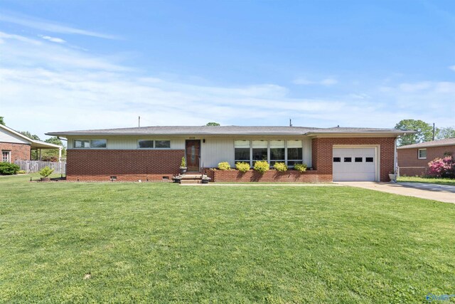 1308 Aston St, Athens, AL 35611 - ranch-style house featuring brick siding, driveway, a front yard, and a garage