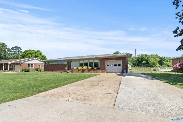 1308 Aston St, Athens, AL 35611 - ranch-style home featuring an attached garage, concrete driveway, a front yard, and brick siding