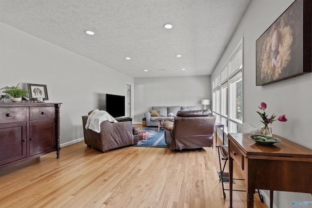 1308 Aston St, Athens, AL 35611 - living area featuring a textured ceiling, baseboards, recessed lighting, and light wood-style flooring