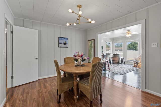 1308 Aston St, Athens, AL 35611 - dining room featuring crown molding, a decorative wall, wood finished floors, baseboards, and ceiling fan with notable chandelier