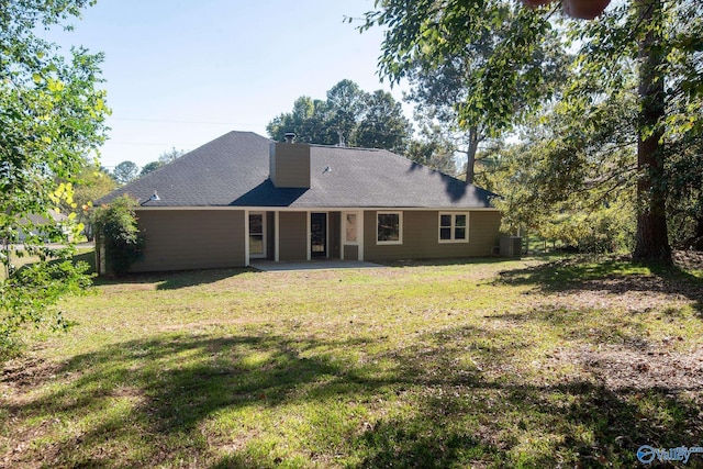 back of property with central air condition unit, a patio, and a lawn