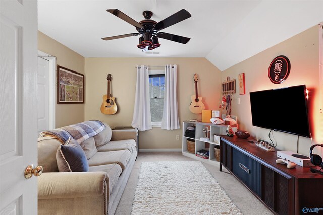 living area featuring vaulted ceiling, light colored carpet, baseboards, and ceiling fan