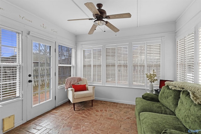 sunroom with visible vents, a healthy amount of sunlight, and a ceiling fan