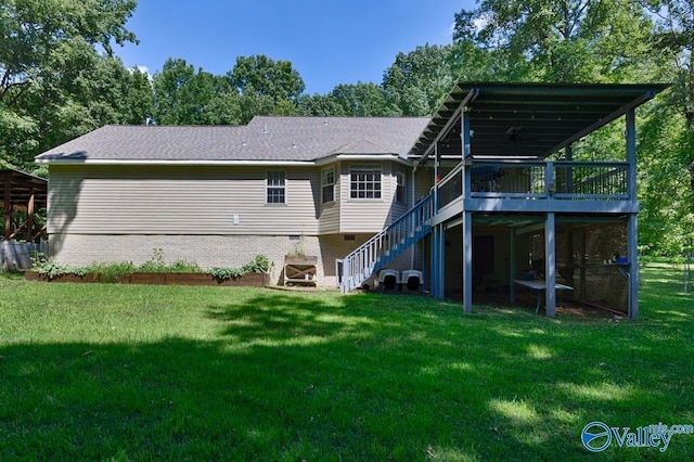 back of property with a wooden deck and a yard