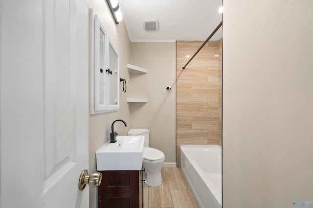 full bathroom with vanity, tiled shower / bath, and toilet