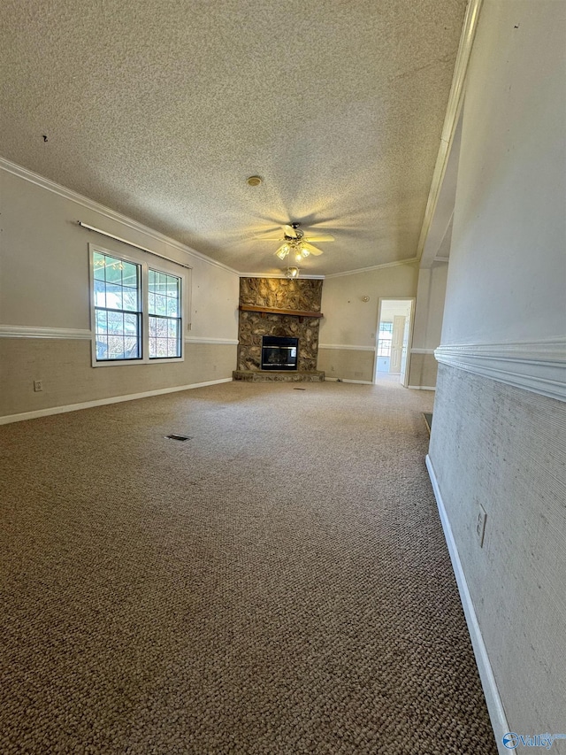 unfurnished living room featuring crown molding, a fireplace, and carpet floors