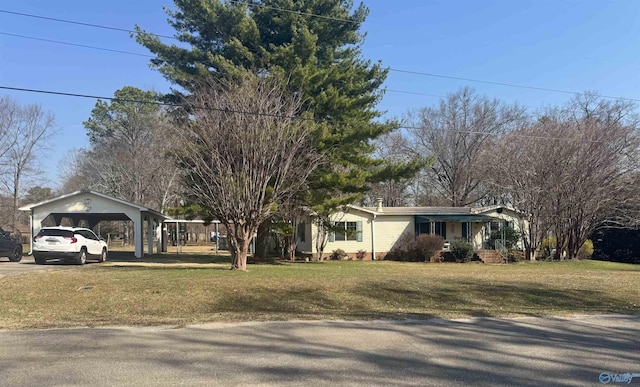 ranch-style house with a carport, driveway, and a front lawn
