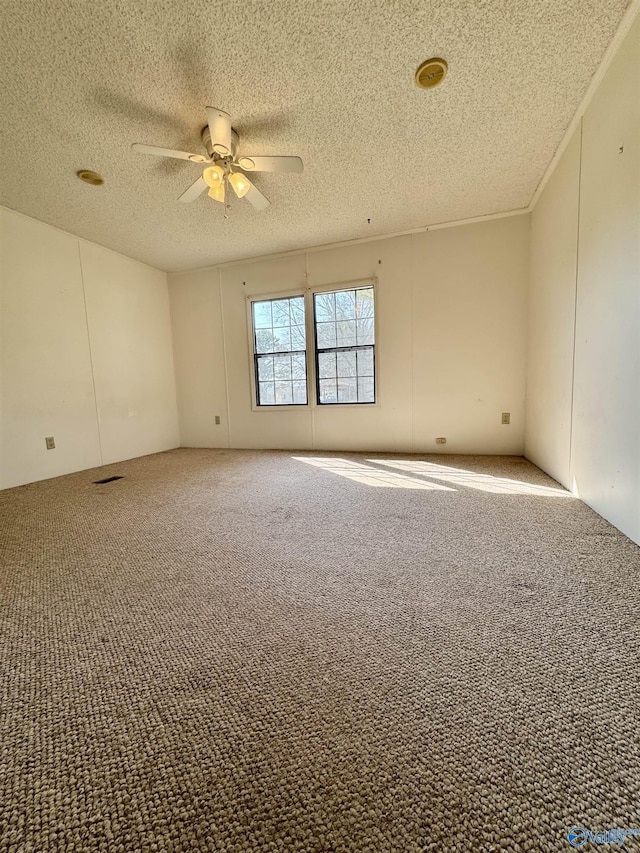 carpeted empty room featuring a textured ceiling and ceiling fan