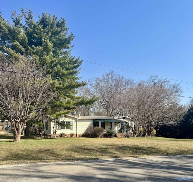 view of front of property with a front lawn and a chimney