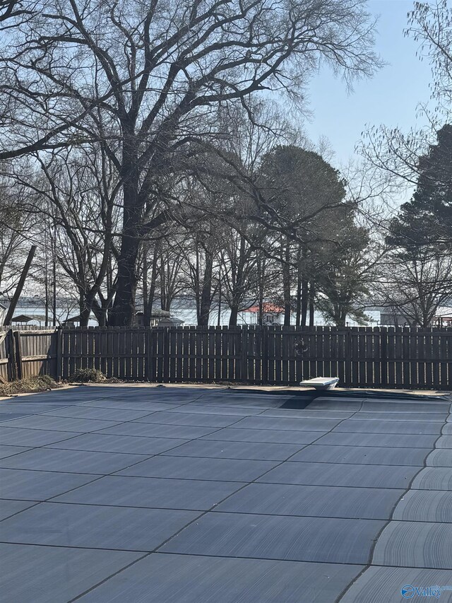 view of swimming pool featuring fence