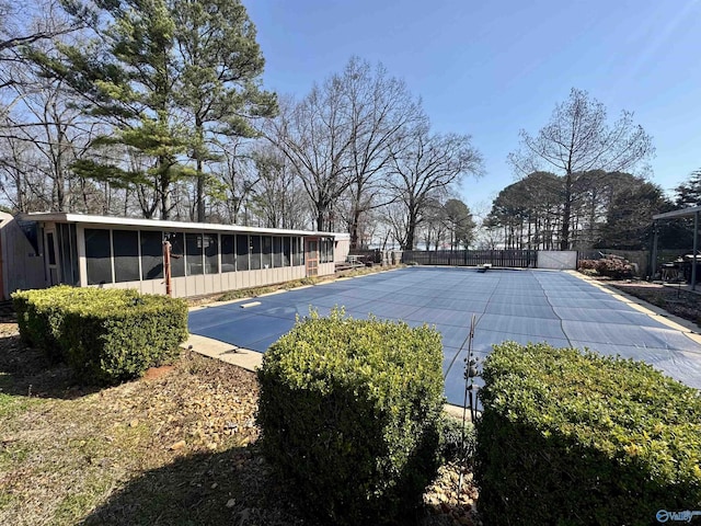 view of yard featuring a fenced in pool, a sunroom, and fence