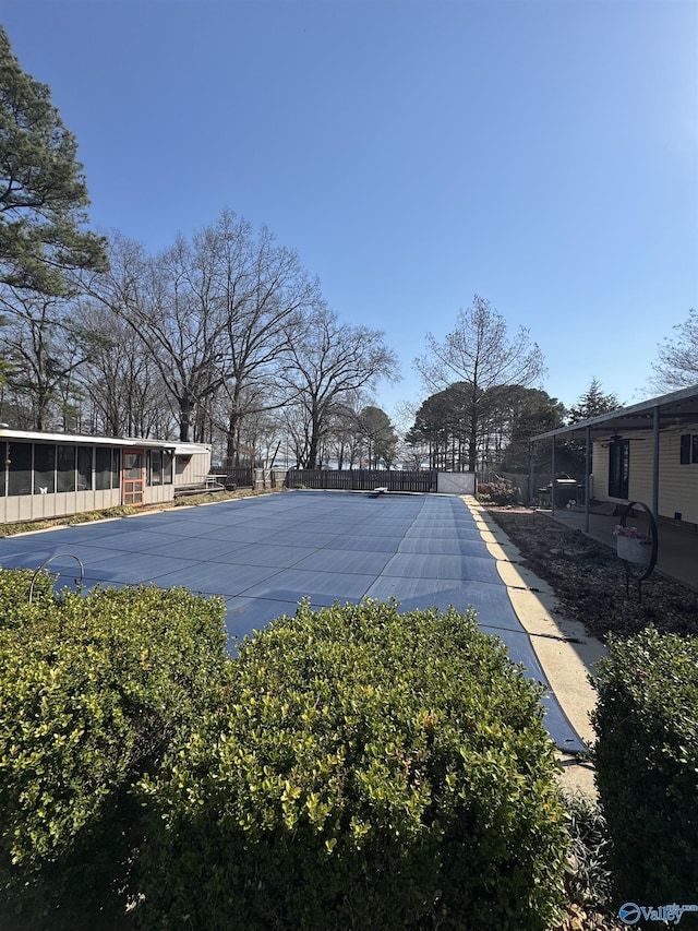 view of yard with a sunroom and fence