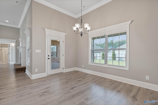 interior space featuring crown molding, light hardwood / wood-style floors, and a notable chandelier