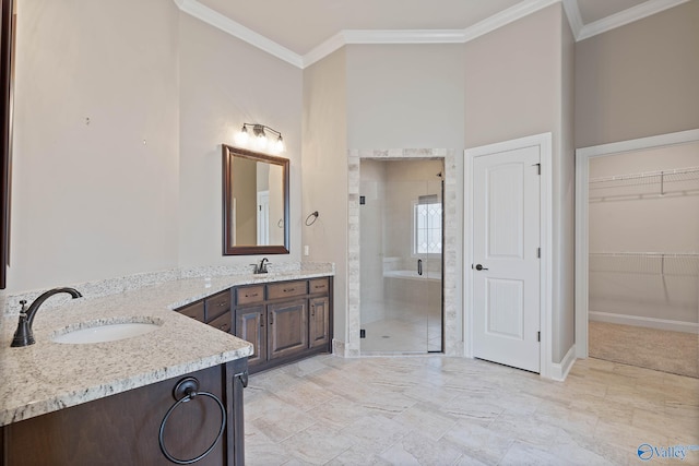 bathroom with walk in shower, crown molding, and vanity