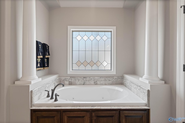 bathroom with decorative columns and a washtub