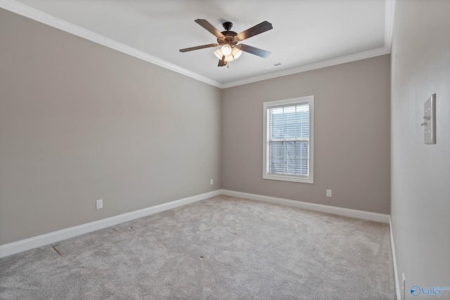 unfurnished room featuring crown molding, light colored carpet, and ceiling fan