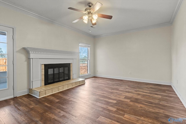 unfurnished living room with dark wood-type flooring, a tile fireplace, and ornamental molding