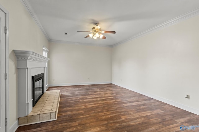 unfurnished living room with ceiling fan, dark wood-type flooring, a tile fireplace, and ornamental molding