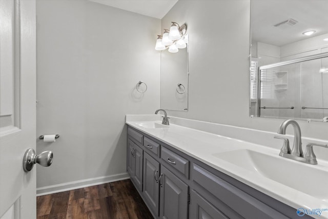 bathroom with vanity, hardwood / wood-style floors, and a shower with door