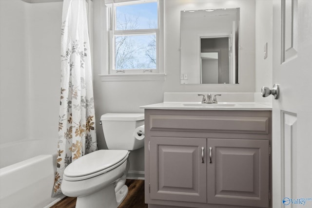 full bathroom featuring vanity, toilet, shower / bathtub combination with curtain, and wood-type flooring