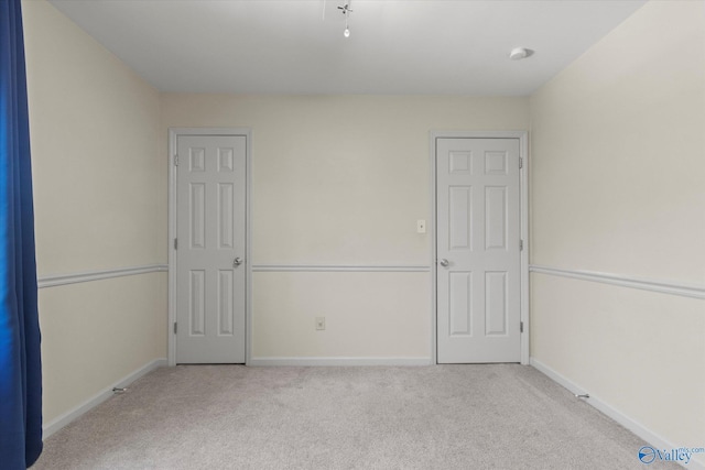 unfurnished room with light carpet