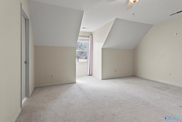 additional living space with ceiling fan, light colored carpet, and lofted ceiling