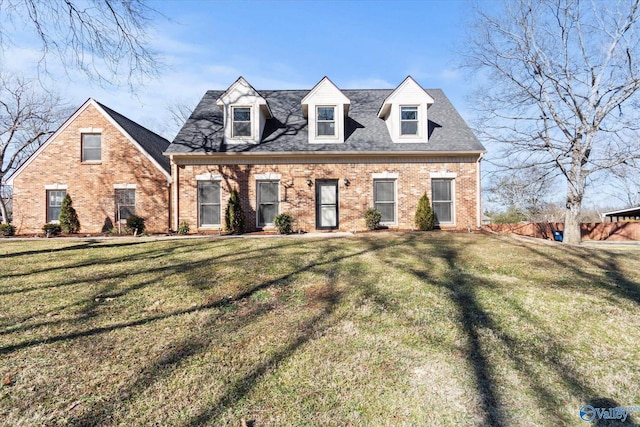 new england style home featuring a front lawn