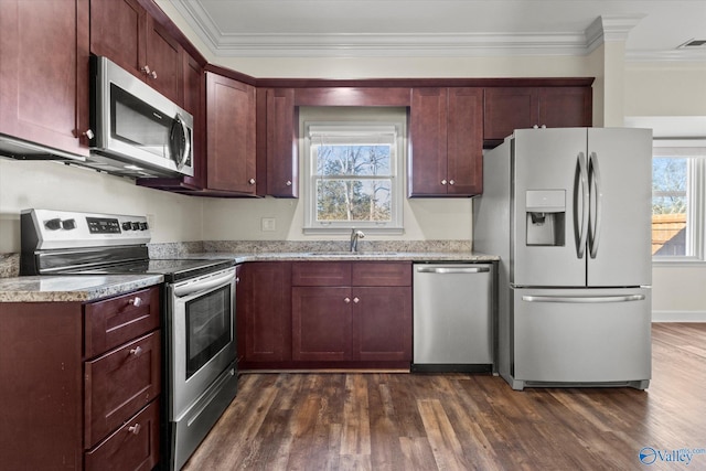 kitchen featuring light stone countertops, appliances with stainless steel finishes, dark hardwood / wood-style flooring, sink, and ornamental molding