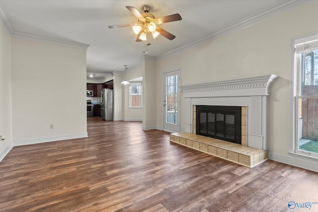 unfurnished living room with a wealth of natural light, dark hardwood / wood-style floors, and crown molding