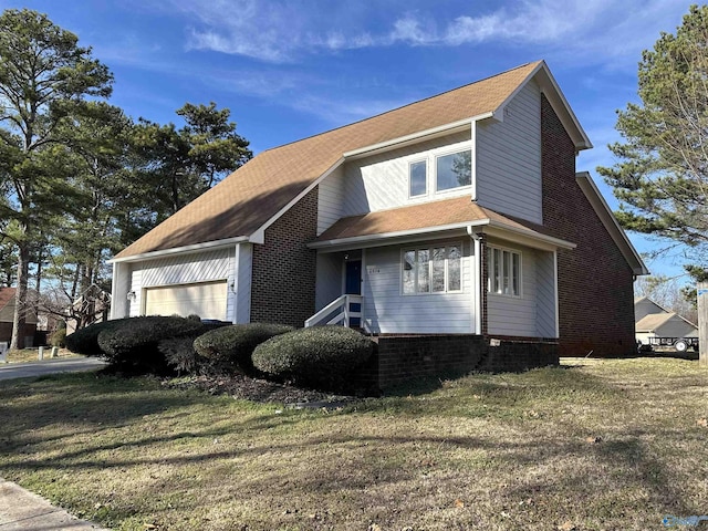 view of front of home with a garage, a front yard, and brick siding