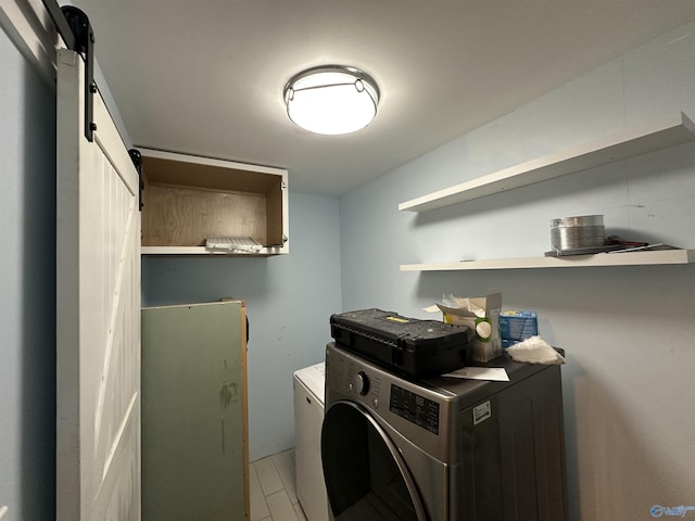 laundry room with laundry area, washer / clothes dryer, and a barn door